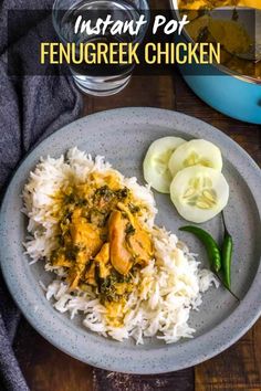 a plate with rice and chicken on it next to some sliced cucumber slices