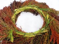 a wreath made out of dried flowers and grass