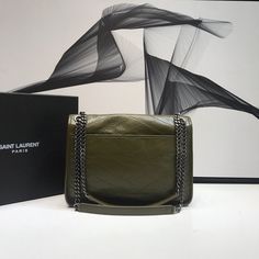 Description S.L Niki Medium Chain Bag In Crinkled Vintage Green For Women 11in/28cm YSL 6331581YG041229 Rep 1:1 Size: 28 x 20 x 8.5 cm / 11 x 7.8 x 3.3 inches (Length x Width x Height) S.L monogram bag with a front flap, made with metal free tanned and organic cotton lining featuring ysl monogram, chain and convertible shoulder strap, central compartment, and open back pocket. Single strap drop: 50 cm; doubled strap drop 28 cm Silver metal hardware Magnetic snap button fastening One central comp Chanel Shirt, Yves Saint Laurent Bags, Monogram Bag, Saint Laurent Bag, Chain Bag, Metal Hardware, Chain Bags, Fashion Handbags, Snap Button