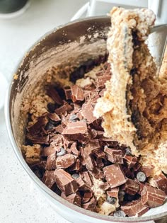 a bowl filled with lots of chocolate and some kind of cake on top of it