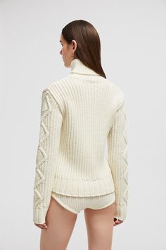 A combination of intricate knitting techniques enrich this wool sweater with a sophisticated texture. Featured in a feminine color palette, the design elevates cold weather looks with its elegant finish. Elegant Knitted Cashmere Sweater, Luxury Knit Sweater For Fall, Luxury Beige Wool Sweater, Elegant Cable Knit Winter Sweater, Luxury White Wool Sweater, Elegant Winter White Cable Knit Sweater, Luxury Long Sleeve Cable Knit Sweater, Luxury Merino Wool Winter Sweater, Elegant Merino Wool Cable Knit Sweater