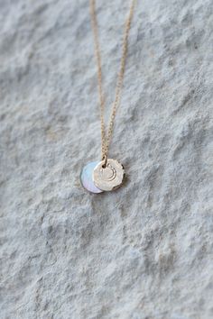 "Where the mountains meet the sea, that is where I get back to me". Featuring an iridescent mother of pearl coin and a gold disc hand stamped with a customized initial or one of our beautiful stamps. Old stock mother of pearl coin, with raw shell back Hand stamped 14K gold fill disc Dainty 14K gold fill cable chain with spring clasp closure Coins measure about 3/8" diameter Choose from a fixed length or add a 2" extender Metal materials made in USA and include recycled content Plastic-free packaging *Please denote letter of choice in checkout notes if you select "initial" stamp. Inquire for bulk pricing for bridesmaid gifts @ info@pelicanhousesc.com Mother of pearl is said to clarify the mind, help protect and carry one through to their goals, and purify the spirit. Qualities: Tranquility. Gold Disc, Printed Swim, Custom Necklace, Shop Swimwear, Country Girls, Cable Chain, Plastic Free, Get Back, Hand Stamped