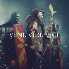 two men dressed in roman armor holding swords and shields with the words veni vidi vici above them