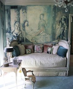 a room with a couch and paintings on the wall