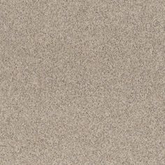 a close up view of the surface of a beige carpet with small speckles