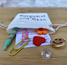 the contents of a craft kit including scissors, buttons and pins