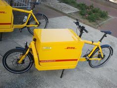 two yellow bicycles parked next to each other