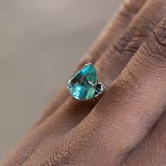 This loose stone is available for a custom ring by Anueva Jewelry. Select your stone first and then select a setting. Add both to your cart and we'll create your ring! 4.66CT TRILLION MONTANA SAPPHIRE, SILKY TEAL GREEN, 10.38X9.70X5.85MM, UNHEATED. Color shifts from teal-blue to teal-green, depending on the source of light available. The sapphire was mined in Montana, USA and is a rare, larger size! It would be great in a Mountainscape setting with antique diamonds on either side. Some visible s Unique Green Jewelry With Accent Stones, Green Gemstones With Accent Stones As A Gift, Green Emerald Fusion Style Ring, Untreated Emerald Jewelry For Anniversary, Green Emerald Fusion Ring, Emerald Cut Green Gemstones With Accent Stones, Green Gemstones With Round Cut Accent Stones, Green Sterling Silver Gemstones With Accent Stones, Green Sterling Silver Fusion Gemstones