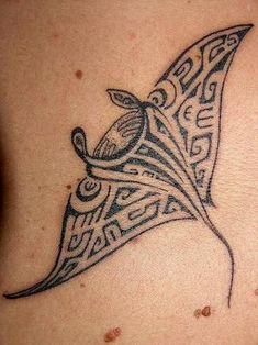 a tattoo design on the back of a woman's shoulder, with an intricate pattern