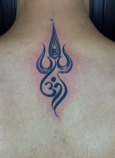 the back of a man's neck with an arabic tattoo on it