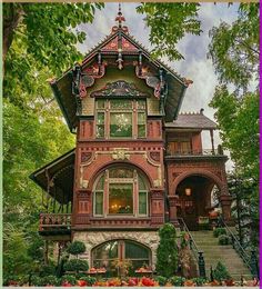 an old victorian style house in the woods