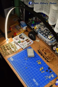 a blue cutting mat sitting on top of a counter next to a knife and other items