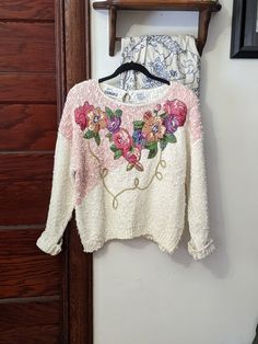 Well if this isn't thee quintessential cottagecore amazingness.  Darling vintage cream and soft pink sweater. Whimsical asymmetric design.  Floral applique, gold swirled cording detail. Knobby boucle type chunky knit. Size vintage large. Would be a  lovely fit oversized and slouchy as well.  Good overall condition, please see pictures. Soft Pink Sweater, Sparkle Purse, Floral Cottage, Whimsical Fairy, Granny Chic, Floral Sweater, Pullover Sweater Women, Asymmetrical Design, Floral Applique