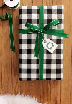 a present wrapped in black and white checkered paper with a green ribbon tied around it