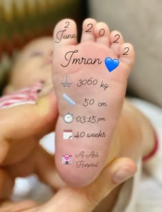 a baby's foot with the birth date written on it