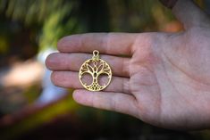 Tree of Life necklace. This pendant has a diameter of 1,2 inches (3 cm) and is crafted by hand in 18k gold. This pendant is a one of a kind design of the 'Tree of Life' symbol. The Tree of Life is an ancient symbol, that has been found in sacred temples all over the world. About the Tree of Life symbol: The Tree of Life is an ancient symbol that has been used all over the world, as a symbol of thriving, harmony, creation and fertility. This one of a kind symbol was designed and created as an ins Bronze Charms Jewelry With Round Pendant, Bronze Jewelry With Charms And Round Pendant, Bronze Round Pendant Jewelry With Charms, Symbolic Brass Jewelry For Anniversary, Nickel-free Brass Jewelry With Round Shape, Spiritual Bronze Jewelry For Anniversary, Symbolic Brass Jewelry With Round Pendant, Symbolic Bronze Jewelry For Gift, Spiritual Bronze Jewelry With Charms