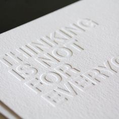 the lettered business card is white with silver foil on it's front and back