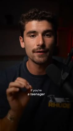 a man holding a microphone in his hand with the words if you're a teenager on it