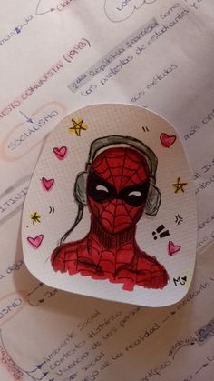 a piece of paper with a drawing of a spiderman on it's face