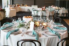 the table is set with plates, silverware and napkins for an elegant dinner