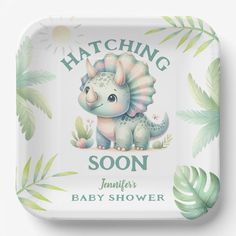 a square plate with an image of a baby dinosaur on it's face and the words hatching soon