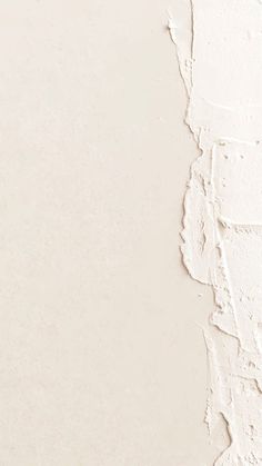 a white wall with peeling paint on it