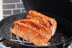 some meat is cooking on a grill outside