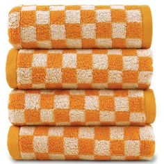 three towels stacked on top of each other in orange and white checkerboard pattern