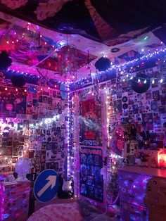 the room is decorated with many lights and pictures on the wall, including an arrow