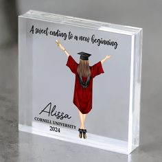 a clear acrylic block with an image of a woman wearing a graduation cap and gown