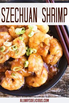 a bowl filled with shrimp and chopsticks on top of a wooden table