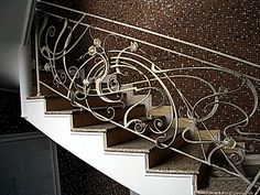 an iron stair railing on the side of a staircase