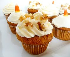 cupcakes with white frosting and candies on top