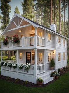 a white house with flowers on the balconies