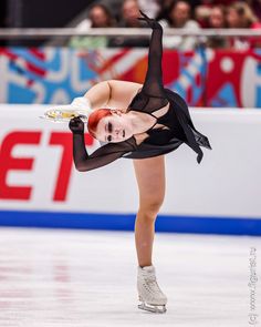 a female figure skating on an ice rink