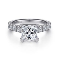 a princess cut diamond engagement ring with pave set shoulders