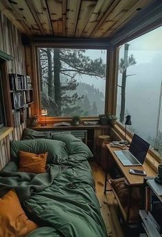 a bed sitting in a bedroom next to a window filled with lots of green blankets