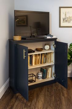 an entertainment center in the corner of a room with a television and bookshelf