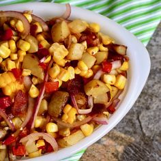 a white bowl filled with corn and onions