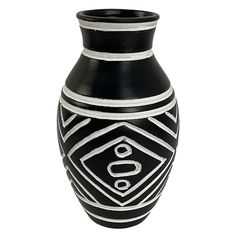 a black and white vase sitting on top of a table