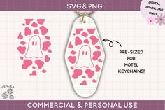 a pink and white keychain with two ghost faces on it, the one has hearts