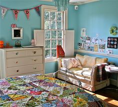 a bed room with a neatly made bed next to a dresser and window in it