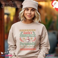 Embrace the festive spirit with our Santa's Favourite Paramedic Ugly Christmas Sweatshirt! This cozy garment, featuring a unique and humorous design, is the ideal choice for medics and first responders during the holiday season. Crafted from a comfortable, midweight cotton-blend material, this sweatshirt is perfect for staying warm while celebrating Christmas. Whether you're on duty or off, showcase your paramedic pride with style. Celebrate the season with a touch of medical humor. This sweatshirt makes for a thoughtful and festive gift for the dedicated paramedic in your life. Spread joy and laughter this Christmas with a sweatshirt that combines comfort and holiday cheer. Ideal for any situation, a unisex heavy blend crewneck sweatshirt is pure comfort. These garments are made from poly Hoodies Vintage, Jolly Af, Winter Hoodie, Tree Shirt, Holiday Sweatshirt, Sweatshirt Christmas, Equal Rights, Look Plus, Christmas Sweatshirts