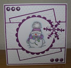 a card with a snowman on the front and purple trimmings around it