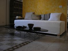 a living room with yellow walls and white furniture