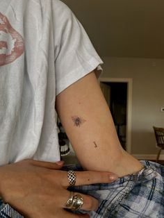 a person with a bee tattoo on their arm