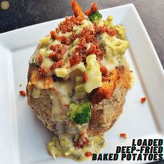 loaded baked potatoes with broccoli and other toppings on a white square plate