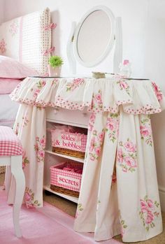 a bedroom with pink furniture and accessories in it