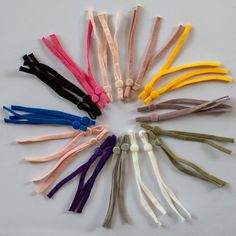 a circle of different colored cords on a white surface