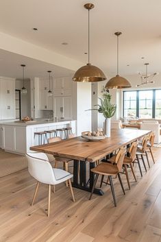 a dining room table surrounded by chairs and lights